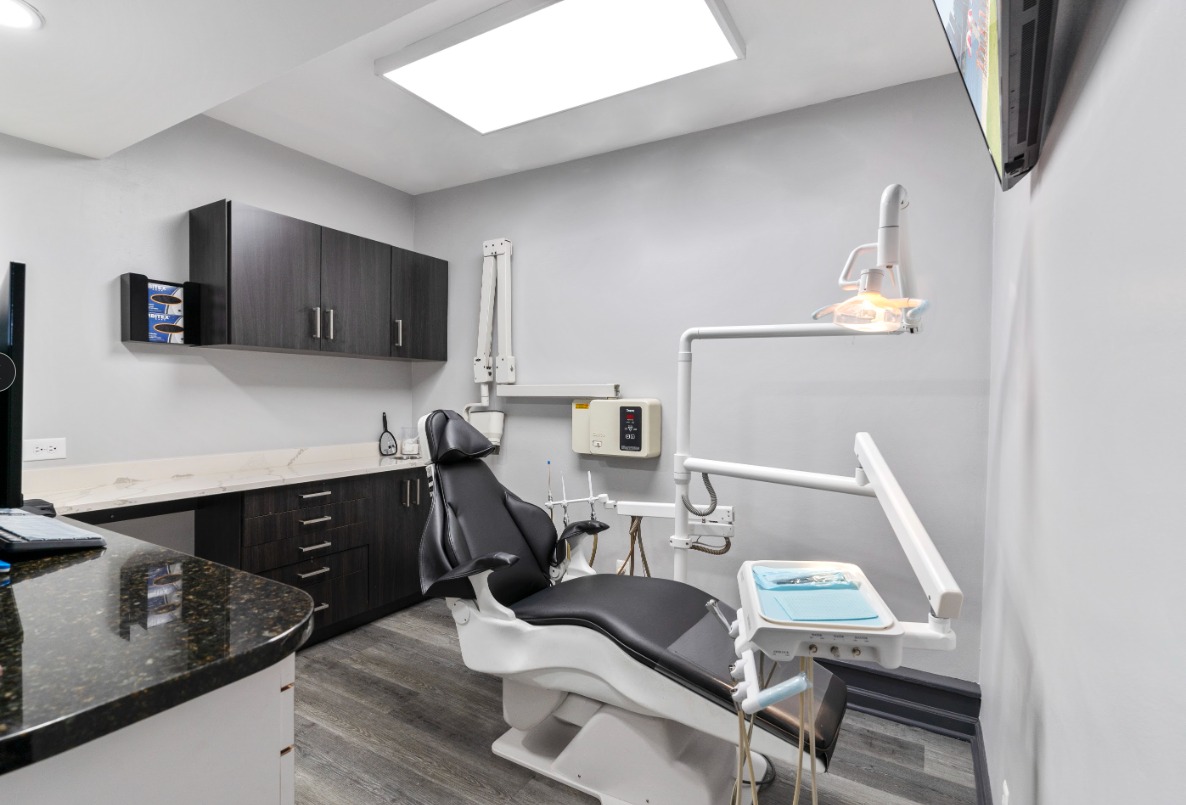 Treatment room with the chair and black cabinetry