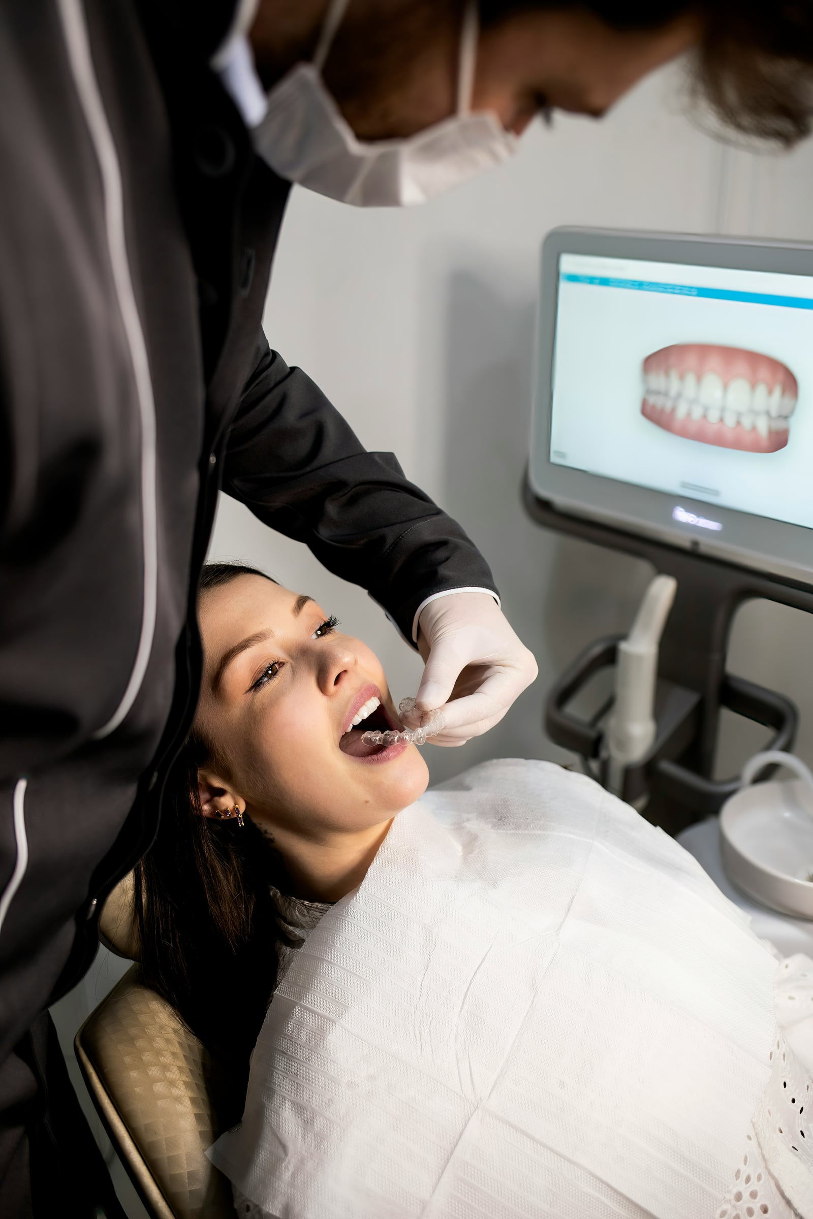 Dentist checking a patient's fit against a digital scan